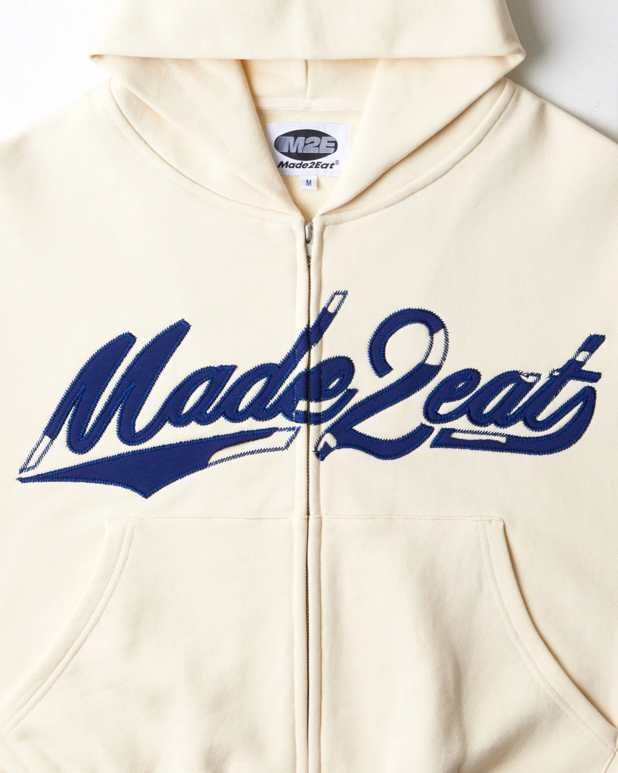 Cream rope stitched hoodie with made2eat stitched across the chest. Made from 420 GSM French terry