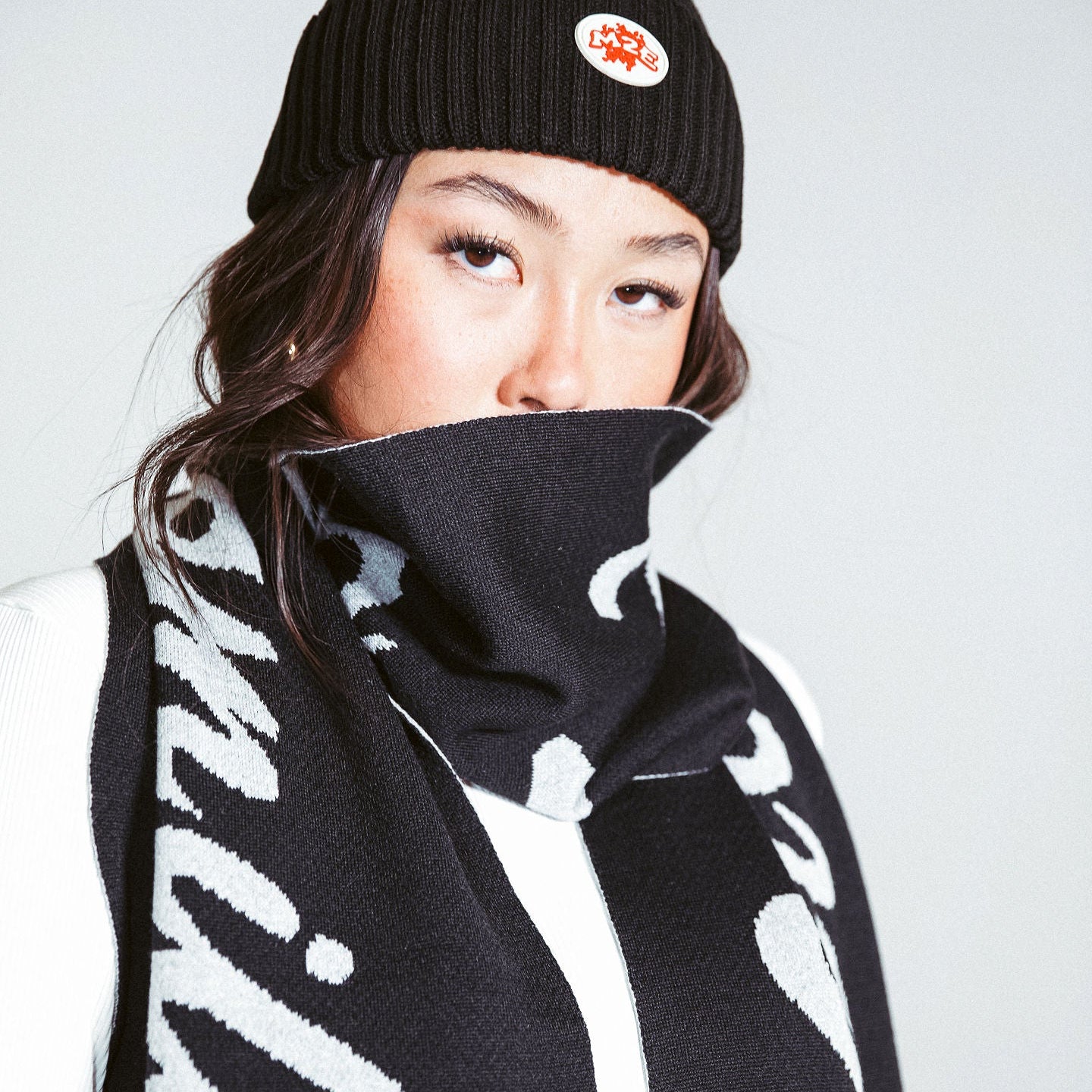 A woman wearing a M2E skully with a scarf wrapped around her face