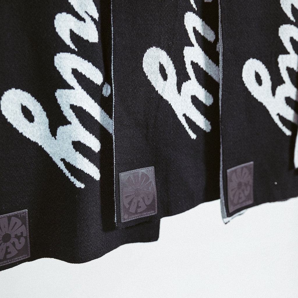 a row of M2E scarves placed in a row beside each other