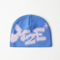 Blue beanie with white text on a light gray background