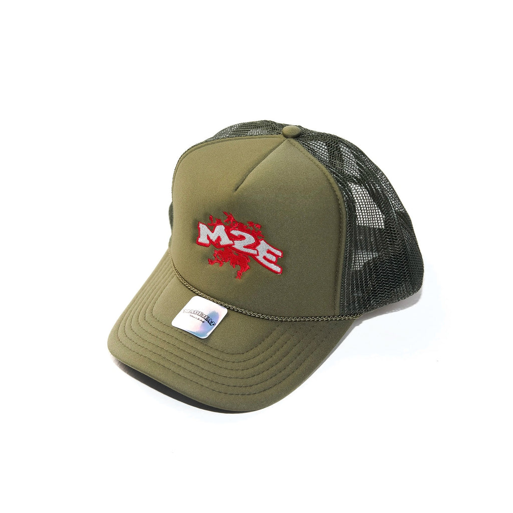 Green M2E trucker cap with black mesh back and red logo on a white background